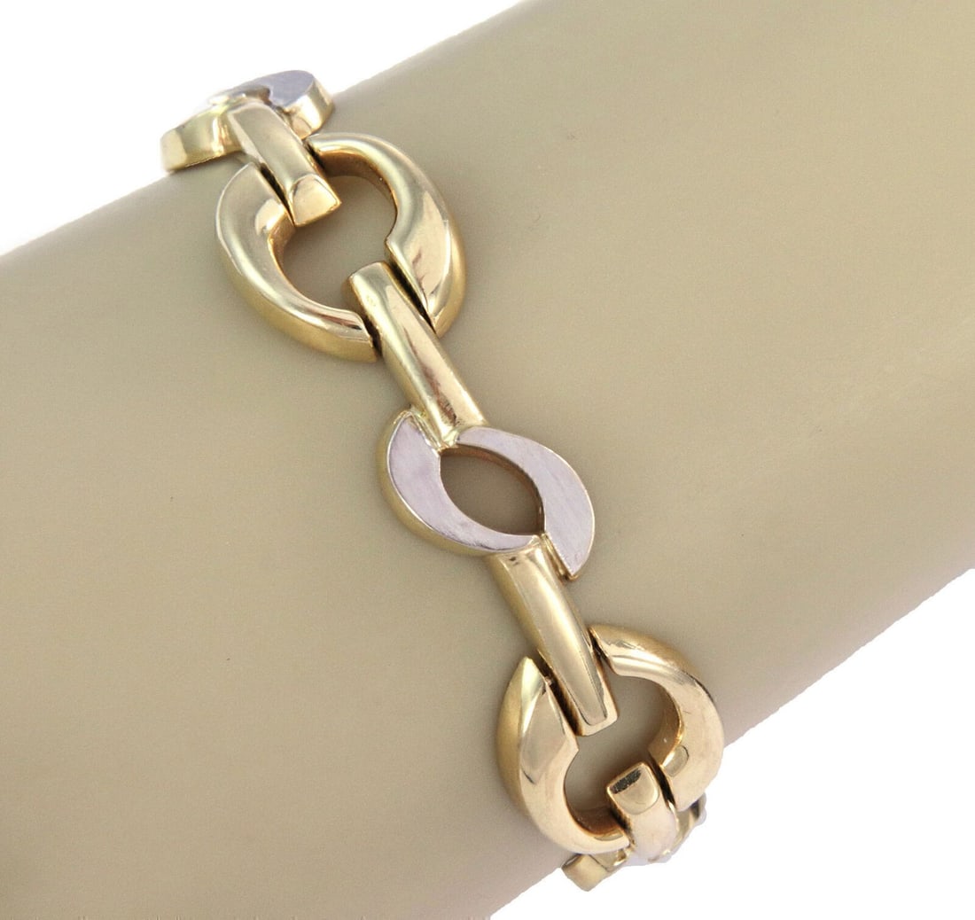 14k Yellow and White Gold Wide Link Bracelet Two Tone Design: 14k Yellow and White Gold Wide Link Bracelet Two Tone Design This wide fancy link bracelet is crafted from 14k two-tone gold, featuring both yellow and white gold elements. The bracelet has a substant