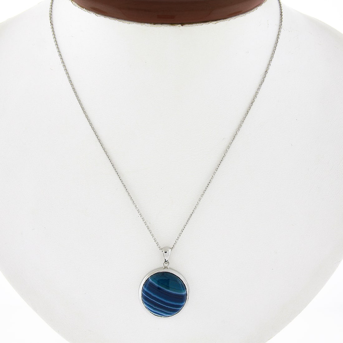 14k White Gold Round Blue Banded Agate Pendant Adjustable Chain: 14k White Gold Round Blue Banded Agate Pendant Adjustable Chain This exquisite pendant features a round cabochon cut blue and white banded agate, set in solid 14k white gold with a stunning bezel styl