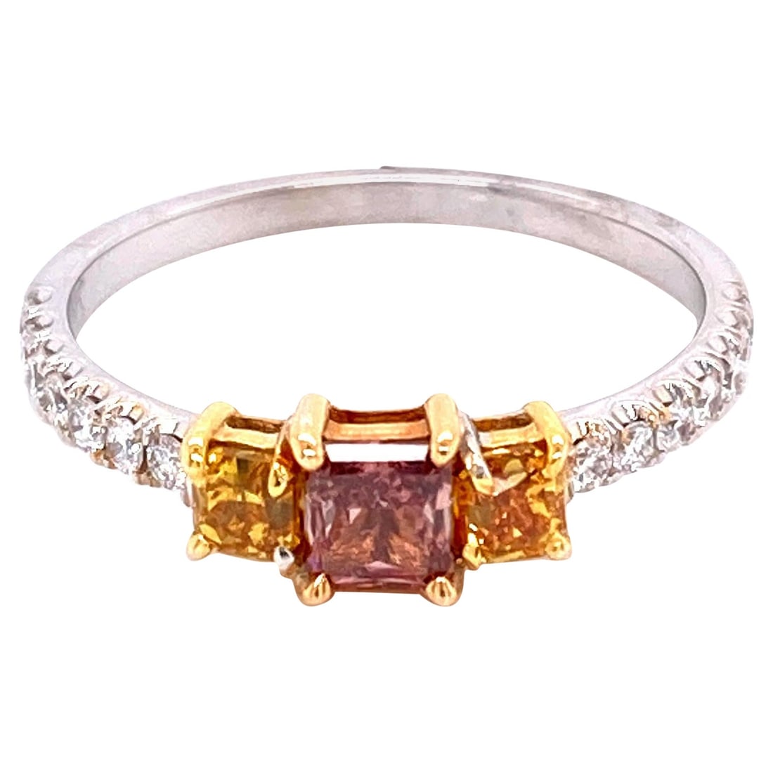 GIA 0.79ct Fancy Pink Yellow Diamond Ring 18k: GIA 0.79ct Fancy Pink Yellow Diamond Ring 18k This exquisite three-stone ring features a stunning combination of fancy deep orangy pink and yellow diamonds, all GIA certified. The ring showcases a tot