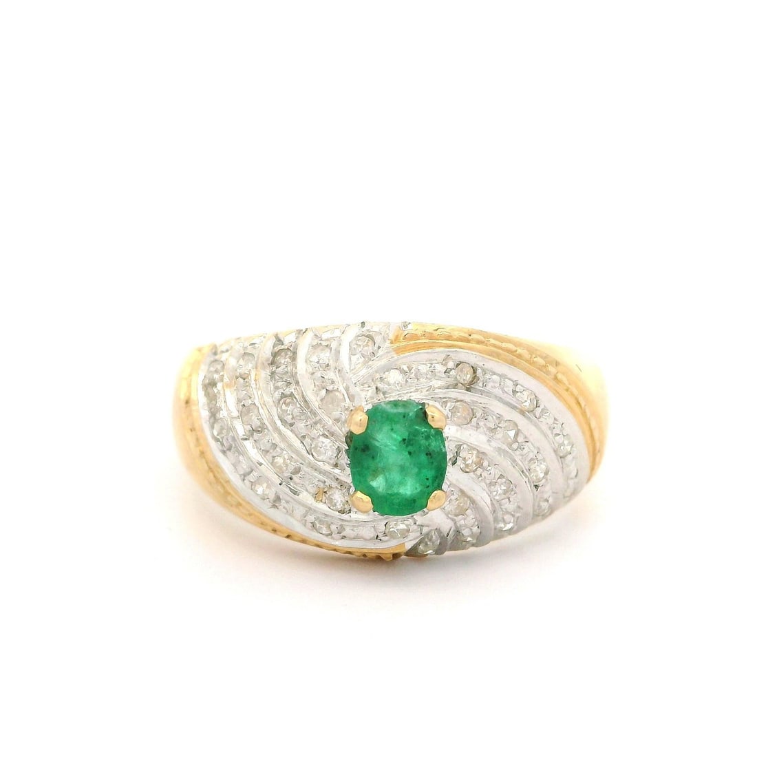 14k Gold Diamond Emerald Spiral Bombe Band Ring: 14k Gold Diamond Emerald Spiral Bombe Band Ring This exquisite Bombe Band Ring features a stunning spiral design crafted from 14k yellow gold with a white gold top. At its center, a natural genuine em