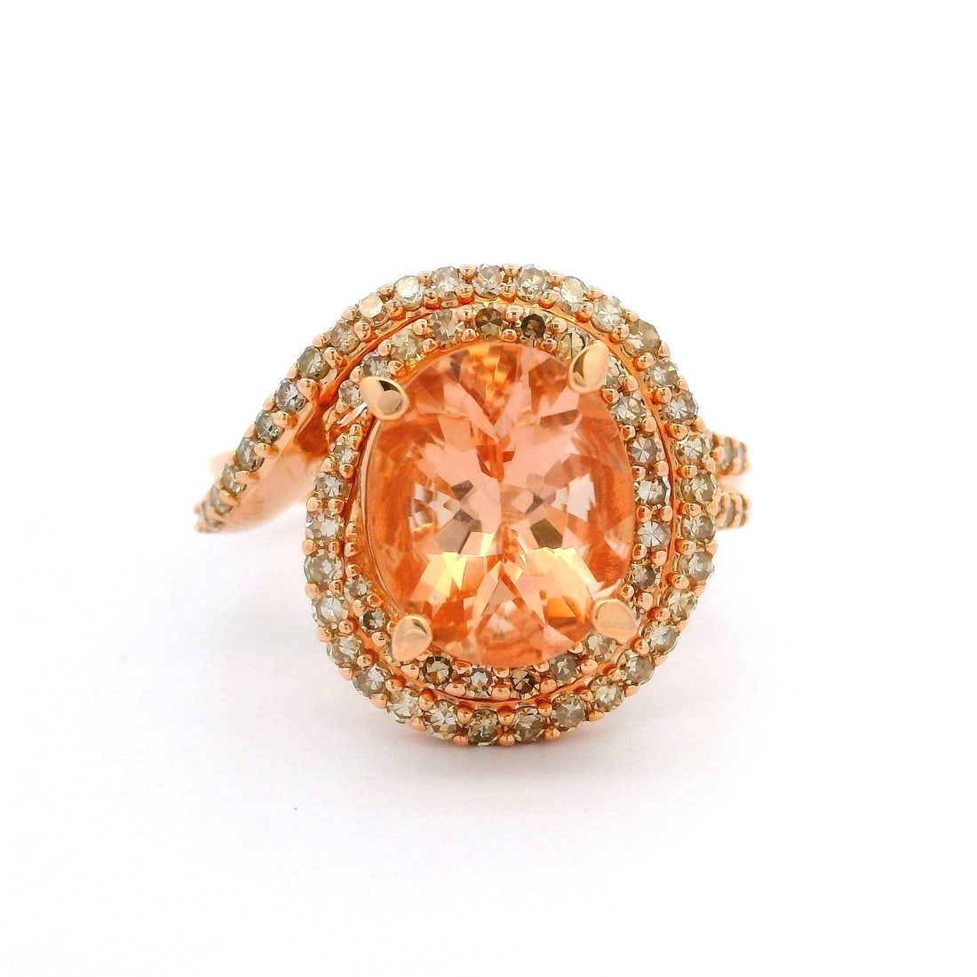 10k Rosy Yellow Gold Oval Morganite Diamond Halo Cocktail Ring: 10k Rosy Yellow Gold Oval Morganite Diamond Halo Cocktail Ring This stunning cocktail ring features a high-profile design crafted from 10k rosy yellow gold. At its center, it showcases a natural genui
