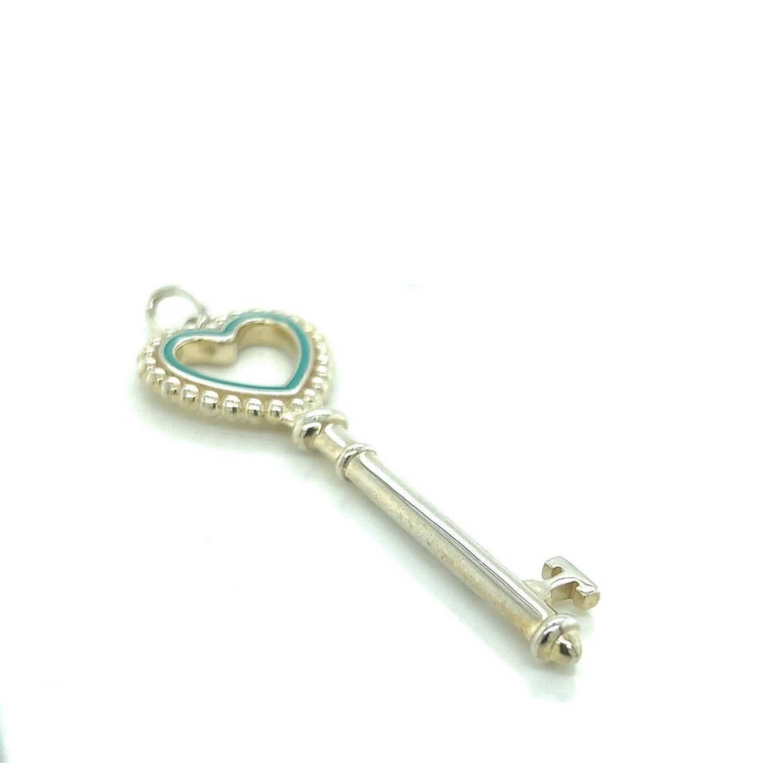 Sterling Silver Heart Key Charm with Mint Green Enamel by Tiffany & Co.: Sterling Silver Heart Key Charm with Mint Green Enamel by Tiffany & Co. Authentic Tiffany & Co. Heart Key charm pendant crafted in sterling silver and adorned with mint green enamel. This collectible