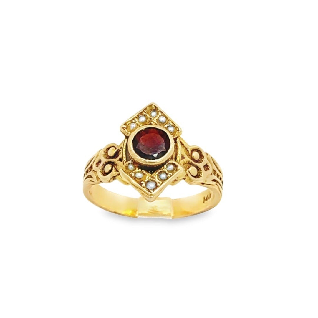 Vintage Victorian Revival 14K Yellow Gold Garnet Seed Pearl Ring: Vintage Victorian Revival 14K Yellow Gold Garnet Seed Pearl Ring This exquisite Vintage Victorian Revival ring is crafted from solid 14K yellow gold and features a stunning bezel set round garnet alon