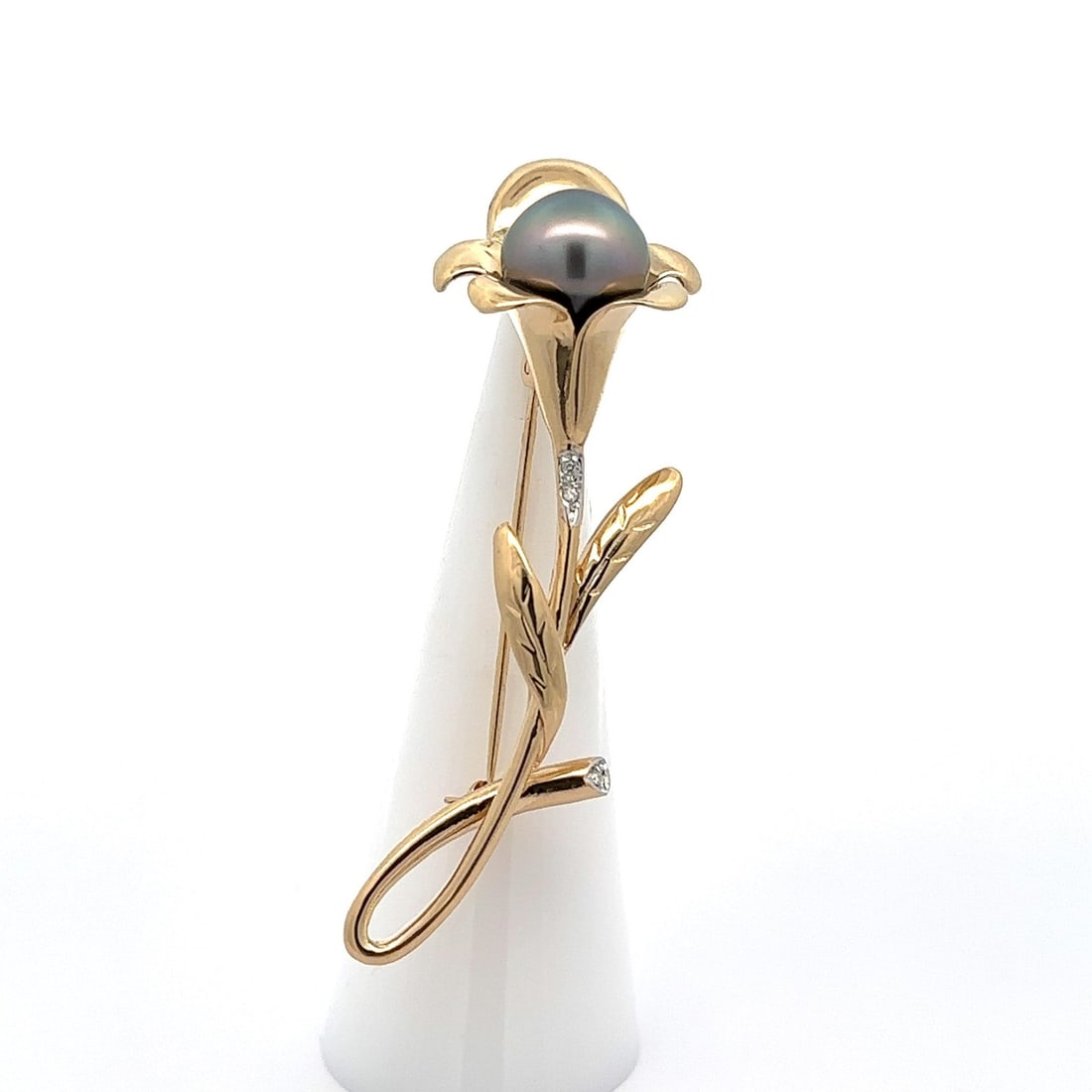 14k Yellow Gold Calla Lily Brooch with Tahitian Pearl and Diamond: 14k Yellow Gold Calla Lily Brooch with Tahitian Pearl and Diamond This exquisite brooch showcases a stunning combination of a genuine Tahitian pearl and sparkling diamond set in solid 14k yellow gold.