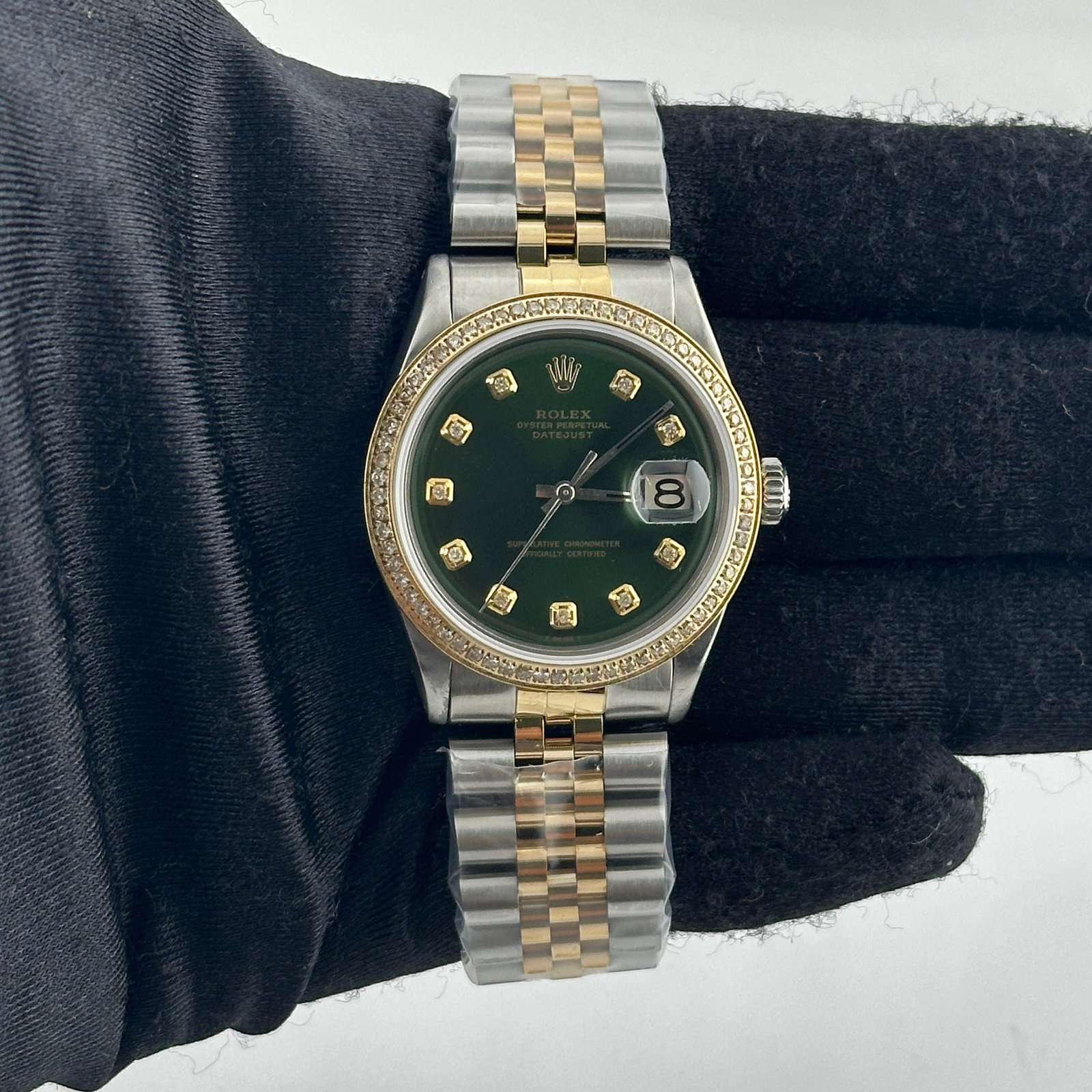 Ladies Rolex Datejust Ref 1601 with Aftermarket Green Diamond Dial and Jubilee Bracelet: Ladies Rolex Datejust Ref 1601 with Aftermarket Green Diamond Dial and Jubilee Bracelet This ladies Rolex Datejust features an aftermarket green diamond dial and a pave plated diamond bezel. It is equ