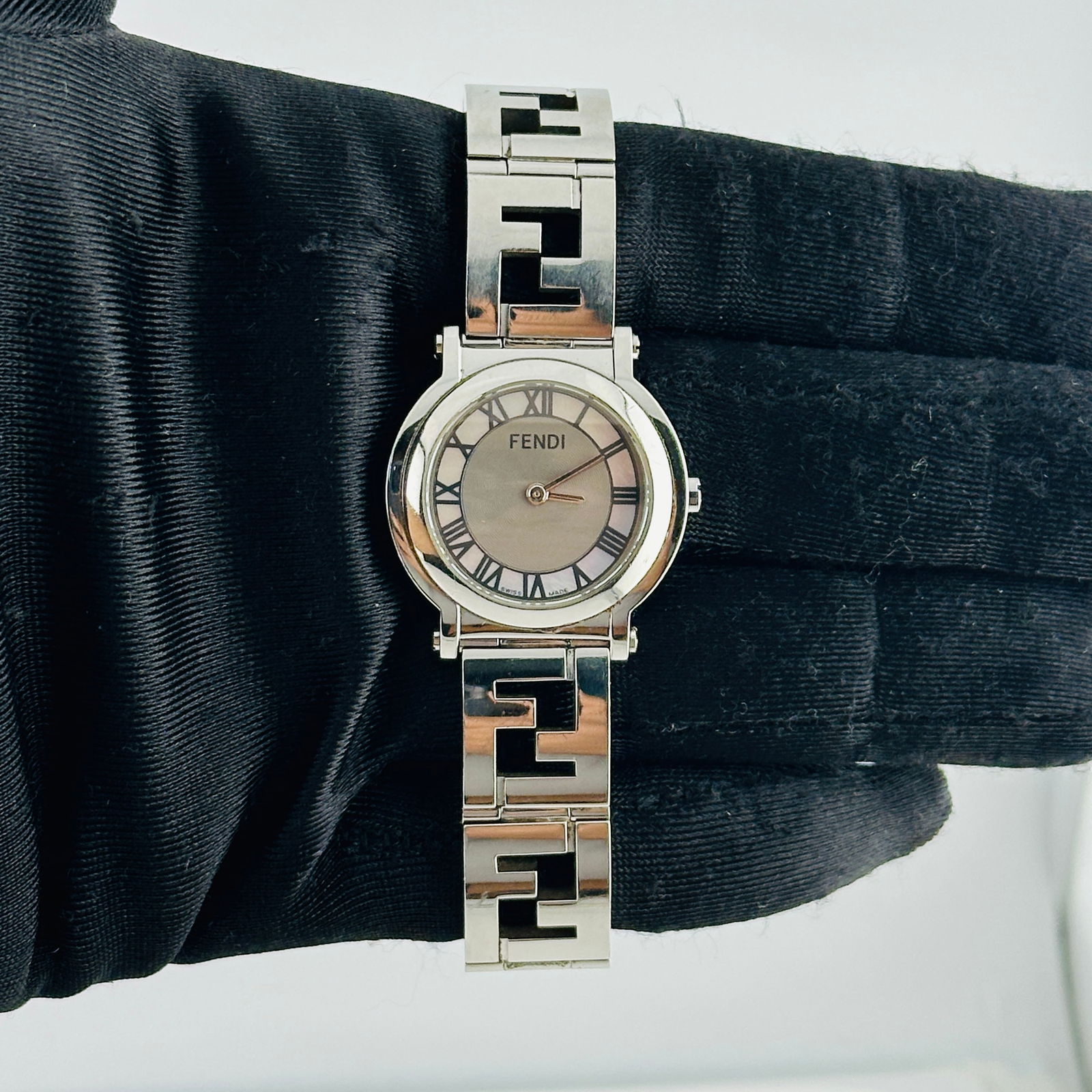 Fendi Ref 6100L Stainless Steel Watch with 2013 Card: Fendi Ref 6100L Stainless Steel Watch with 2013 Card This Fendi Orologi Mop Roman Dial Ref 6100L features a stainless steel case with a mother of pearl Roman numeral dial. The watch comes with its ori