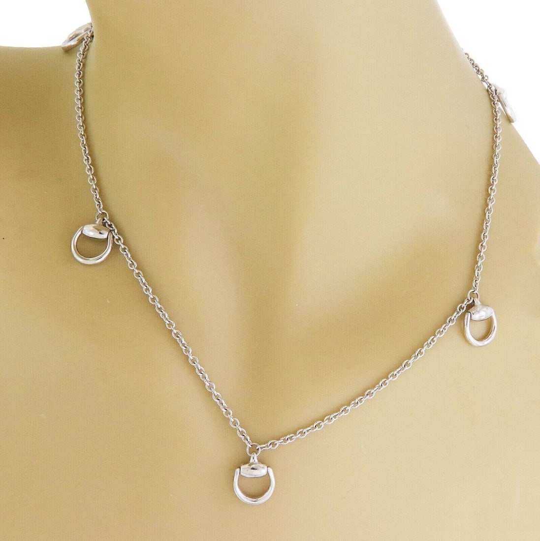 Gucci 18k White Gold Necklace with Six Horsebit Motifs 16.5 Inch: Gucci 18k White Gold Necklace with Six Horsebit Motifs 16.5 Inch This Gucci necklace is crafted from solid 18k white gold and features six polished horsebit motifs spaced along a refined chain. The el