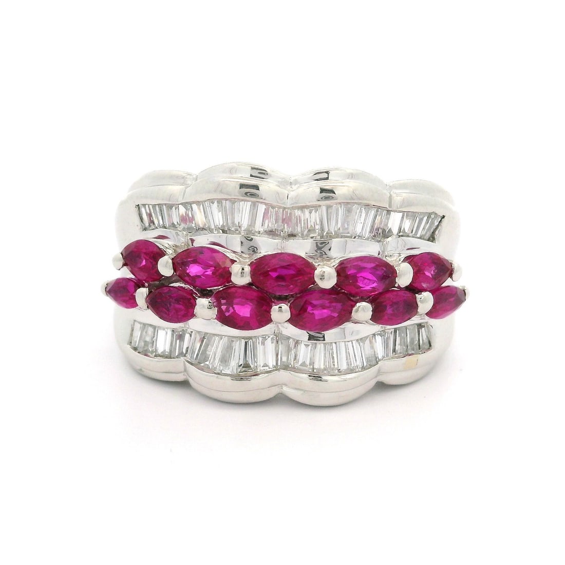Platinum 2.41ct Marquise Ruby Baguette Diamond Wide Band Ring: Platinum 2.41ct Marquise Ruby Baguette Diamond Wide Band Ring This exquisite platinum band ring features a stunning marquise-cut ruby at its center, surrounded by channel-set baguette diamonds. The vi