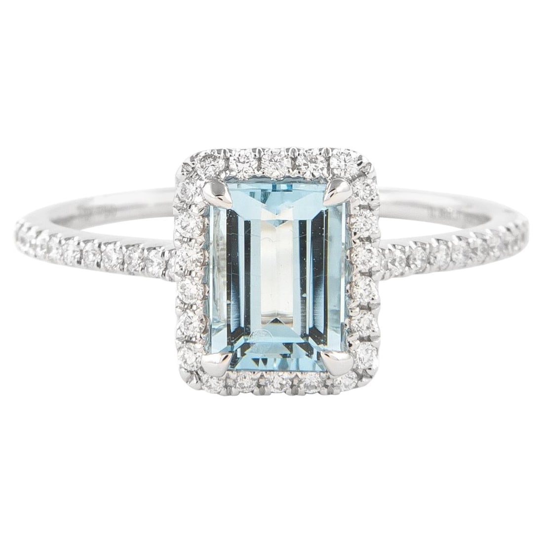 1.07ct Emerald Cut Aquamarine Diamond Halo Ring 18k White Gold: 1.07ct Emerald Cut Aquamarine Diamond Halo Ring 18k White Gold This exquisite ring features a stunning 1.07ctt total gemstone weight, showcasing an emerald cut aquamarine weighing 0.88 carats, surroun