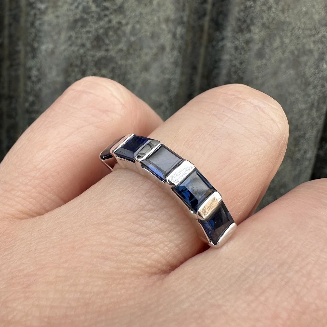 Five Stone Platinum Band Ring with 2.69ctw Blue Square Sapphires: Five Stone Platinum Band Ring with 2.69ctw Blue Square Sapphires This un-used band ring features five square step cut natural sapphires in a channel bar setting, totaling 2.69 carats. The sapphires di