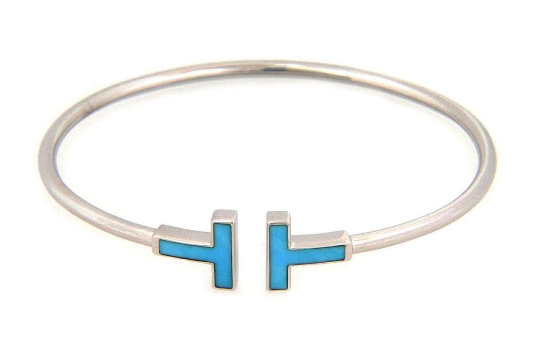 Tiffany T Wire Turquoise 18k White Gold Flex Cuff Bracelet: Tiffany T Wire Turquoise 18k White Gold Flex Cuff Bracelet This Tiffany & Co. T Wire flex cuff bangle bracelet is expertly crafted in solid 18k white gold and features a vibrant turquoise stone. The d