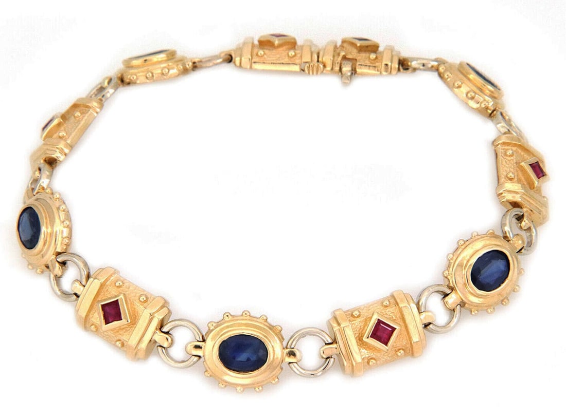 14k Yellow Gold Bracelet with Sapphire and Ruby Gemstone Bar Links: 14k Yellow Gold Bracelet with Sapphire and Ruby Gemstone Bar Links This finely crafted bracelet features alternating oval and textured bar links in solid 14k yellow gold with a high-polished finish. E
