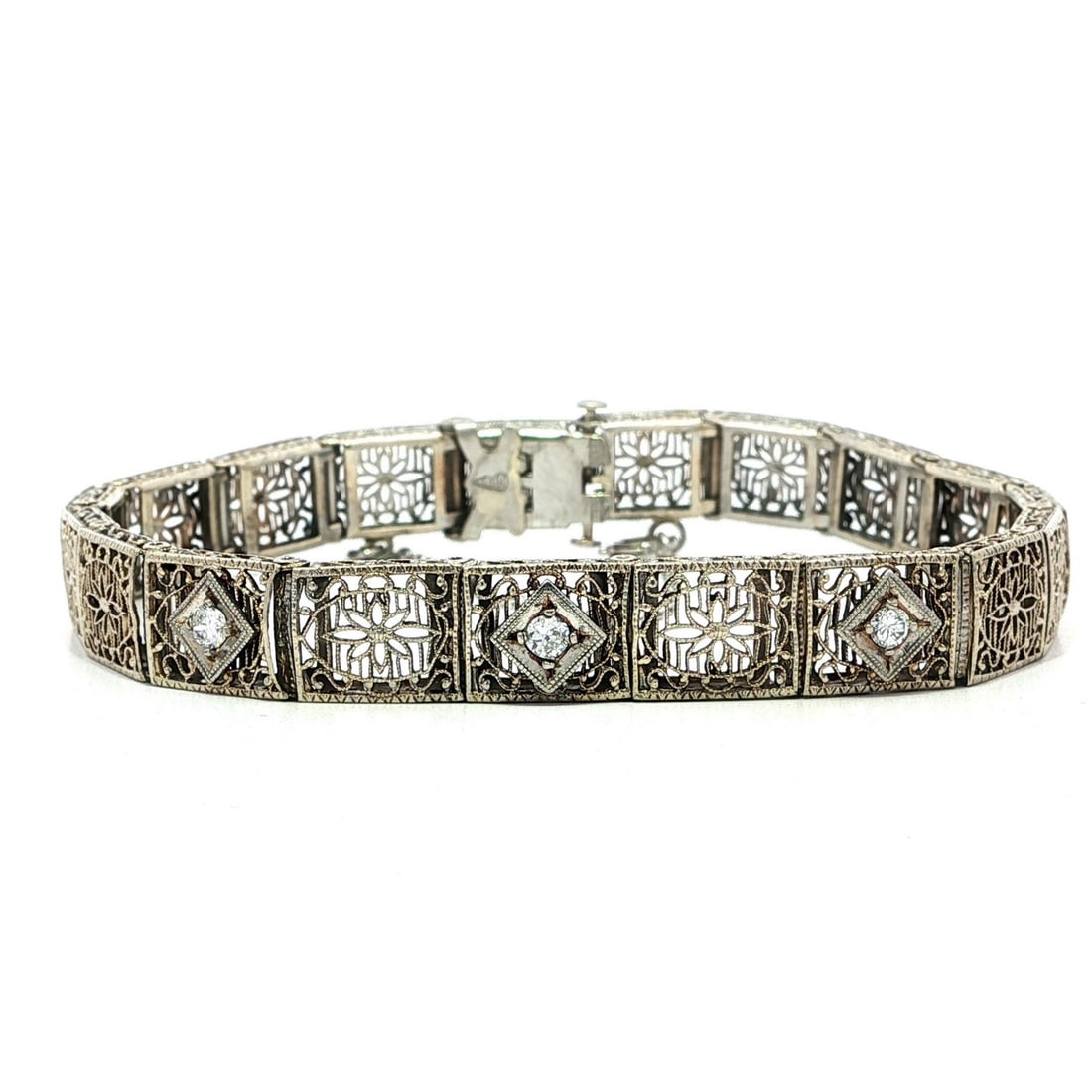Antique Art Deco 0.15ctw Diamond Floral Filigree Bracelet in 10k White Gold: Antique Art Deco 0.15ctw Diamond Floral Filigree Bracelet in 10k White Gold This exquisite Antique Art Deco bracelet features a stunning floral filigree design and is adorned with three natural genuin