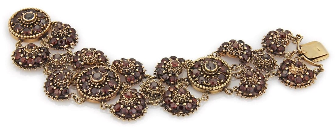 Wide Floral Bracelet with Bohemian Garnet in 14k Yellow Gold: Wide Floral Bracelet with Bohemian Garnet in 14k Yellow Gold This wide floral bracelet features vibrant Bohemian garnet gemstones set in 14k yellow gold. The chain style and intricate floral motif cre