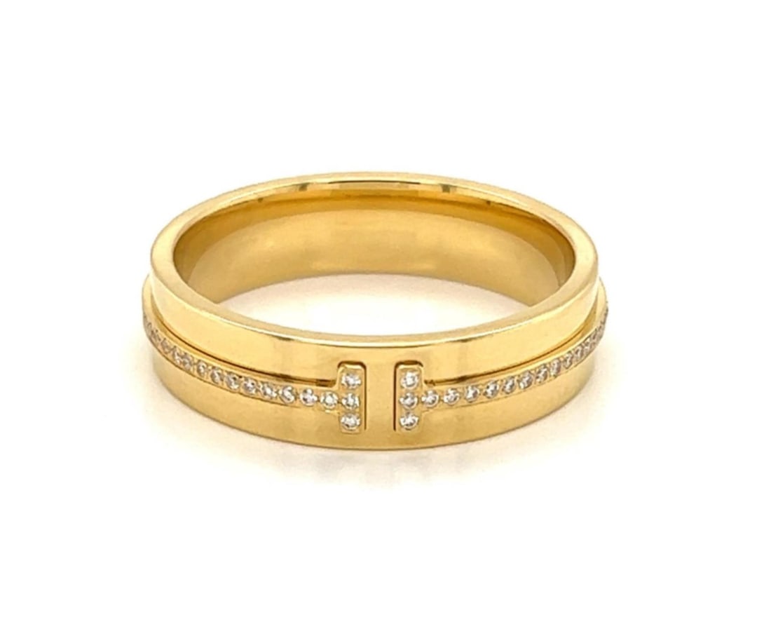 Tiffany T 18k Yellow Gold Diamond Band Ring 5.5mm Size 9.5: Tiffany T 18k Yellow Gold Diamond Band Ring 5.5mm Size 9.5 This Tiffany & Co. T collection ring is expertly crafted from solid 18k yellow gold with a polished finish. The 5.5mm wide band showcases a s