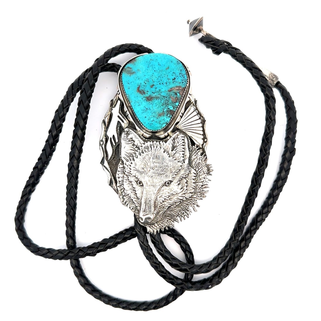 Sterling Silver Wolf Bolo Tie with Turquoise by Dan Nieto on Black Leather: Sterling Silver Wolf Bolo Tie with Turquoise by Dan Nieto on Black Leather This vintage bolo tie features a detailed wolf design crafted by Dan Nieto in sterling silver, complemented by a bezel-set, c