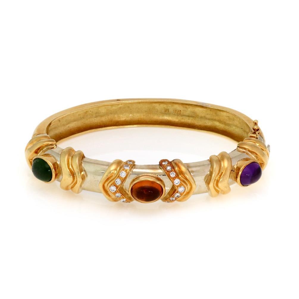 Estate 18k Yellow Gold Bracelet with Diamonds and Gemstones: Estate 18k Yellow Gold Bracelet with Diamonds and Gemstones Experience elegance with this stunning Estate bracelet, expertly crafted from 18k yellow gold. The design features three exquisite oval cabo