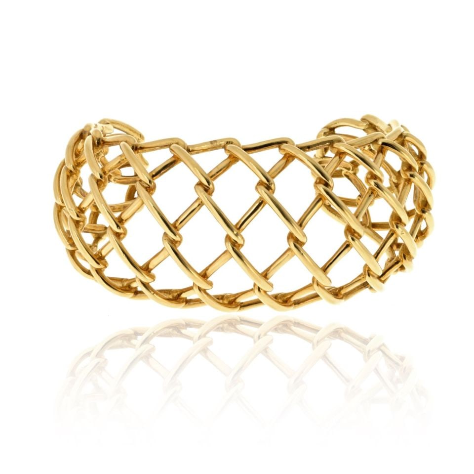 David Webb 18K Yellow Gold Openwork Cuff Bracelet Signed by WEBB: David Webb 18K Yellow Gold Openwork Cuff Bracelet Signed by WEBB This exquisite David Webb cuff bracelet is crafted from 18K yellow gold, weighing 61.2 grams. Its light and airy openwork design create