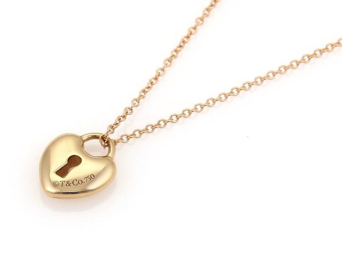 18k Rose Gold Heart Padlock Pendant Necklace by Tiffany & Co.: 18k Rose Gold Heart Padlock Pendant Necklace by Tiffany & Co. This vintage Tiffany & Co. necklace features a heart-shaped padlock pendant crafted from 18k rose gold. Signed by Tiffany & Co., the origi