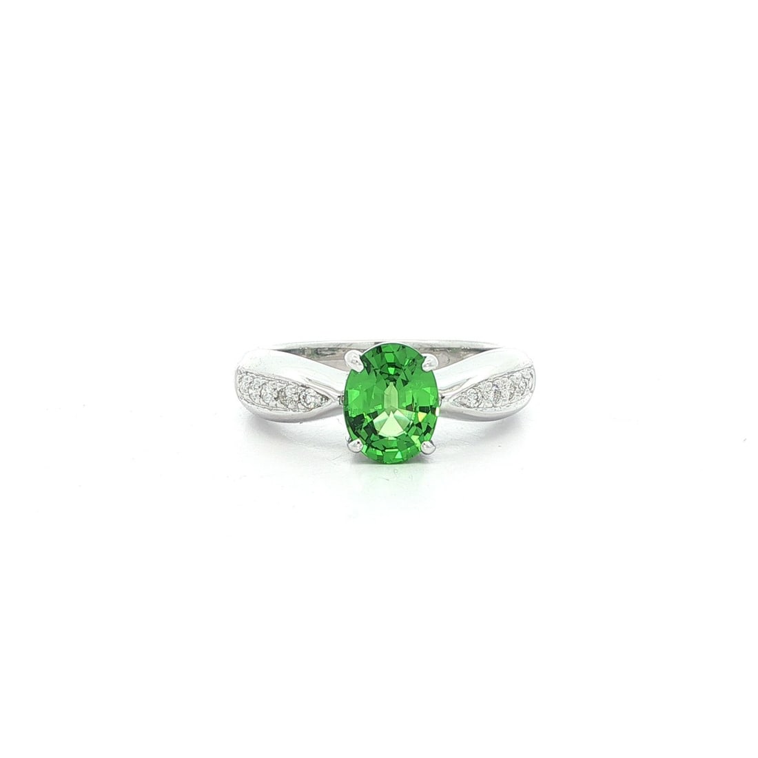 18k White Gold 1.09ct Tsavorite & Diamond Solitaire Band Ring: 18k White Gold 1.09ct Tsavorite & Diamond Solitaire Band Ring This exquisite solitaire band ring features a stunning natural green tsavorite gemstone, expertly crafted in solid 18k white gold. The ova