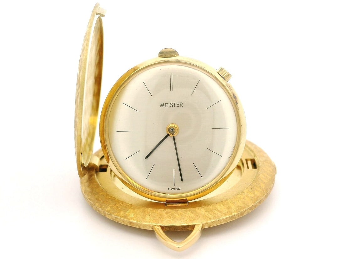 Vintage Meister 18k Gold Hammered Desk Coin Watch Mechanical: Vintage Meister 18k Gold Hammered Desk Coin Watch Mechanical This exquisite Vintage Collectible Meister Desk Coin Watch features a stunning 18k Gold Florentine Hammered Finish. The timepiece showcases
