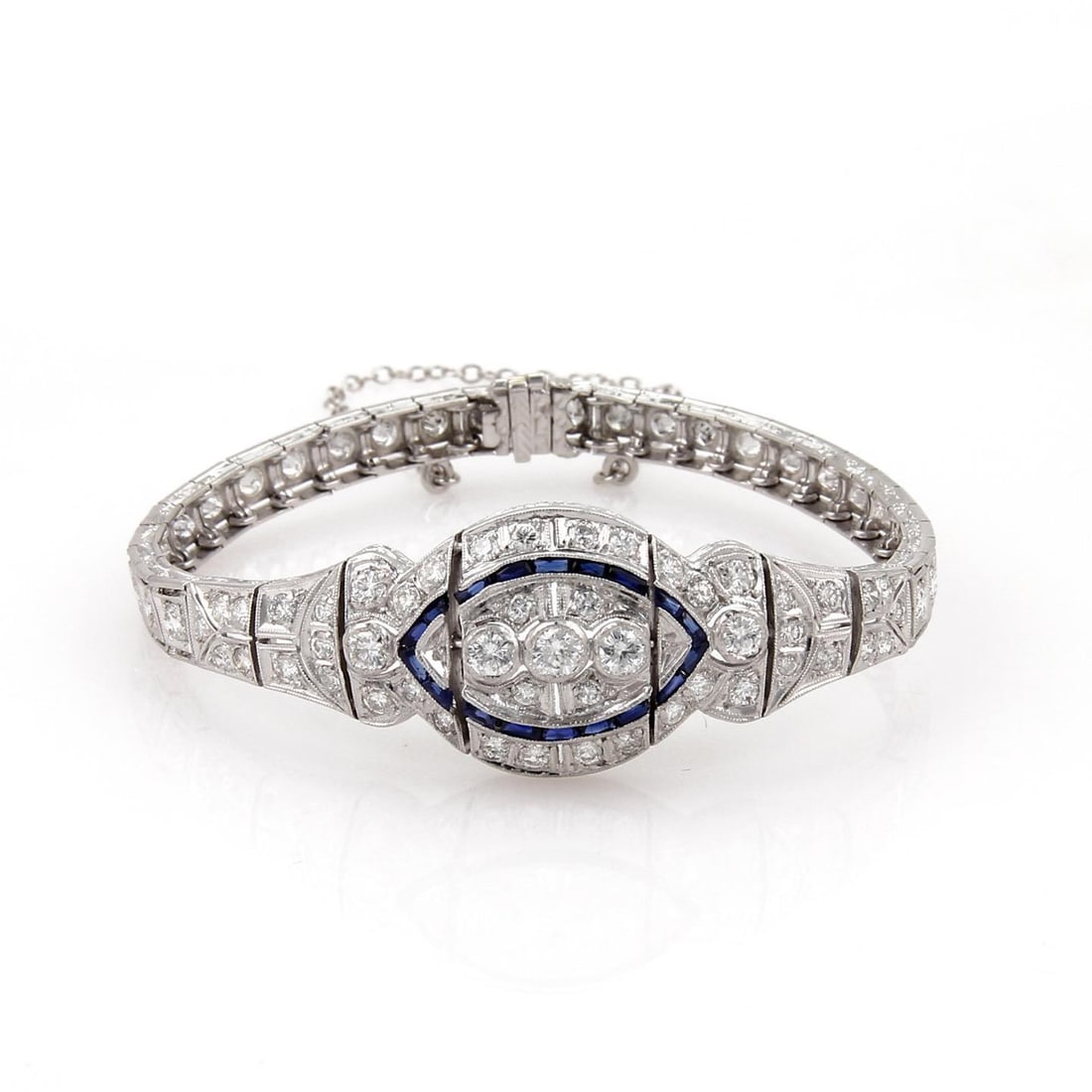 Art Deco Platinum Bracelet 2.75ct Diamonds 70pts Sapphires Milgrain Design: Art Deco Platinum Bracelet 2.75ct Diamonds 70pts Sapphires Milgrain Design This exquisite Art Deco bracelet is meticulously crafted from platinum, showcasing a brilliant high-polished finish. The desi
