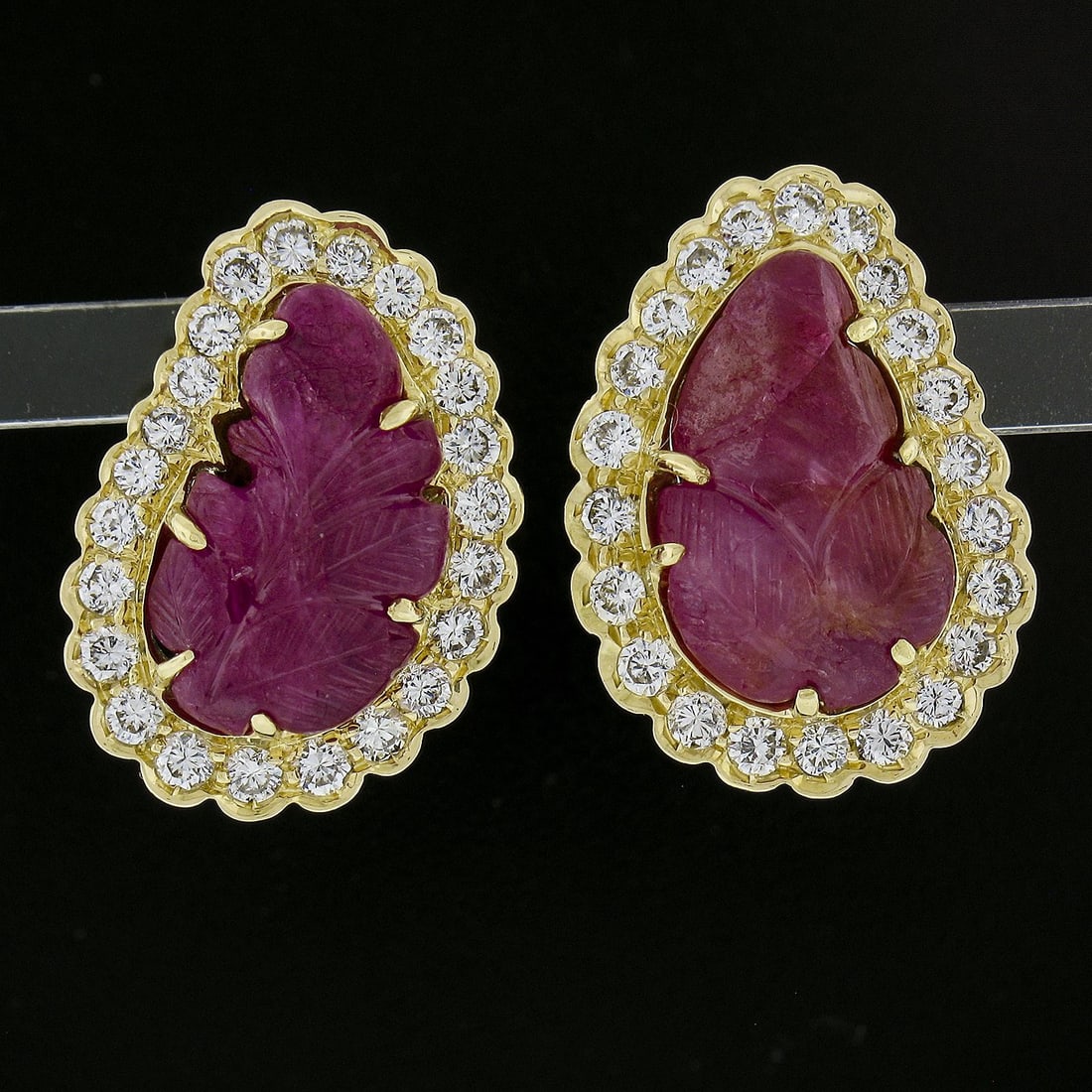 17k Yellow Gold Ruby Leaf Design Diamond Halo Clip On Earrings: 17k Yellow Gold Ruby Leaf Design Diamond Halo Clip On Earrings Exquisite and vibrant, these Yellow Gold Carved Leaf Ruby Clip-On Earrings feature a stunning design that showcases two natural genuine r