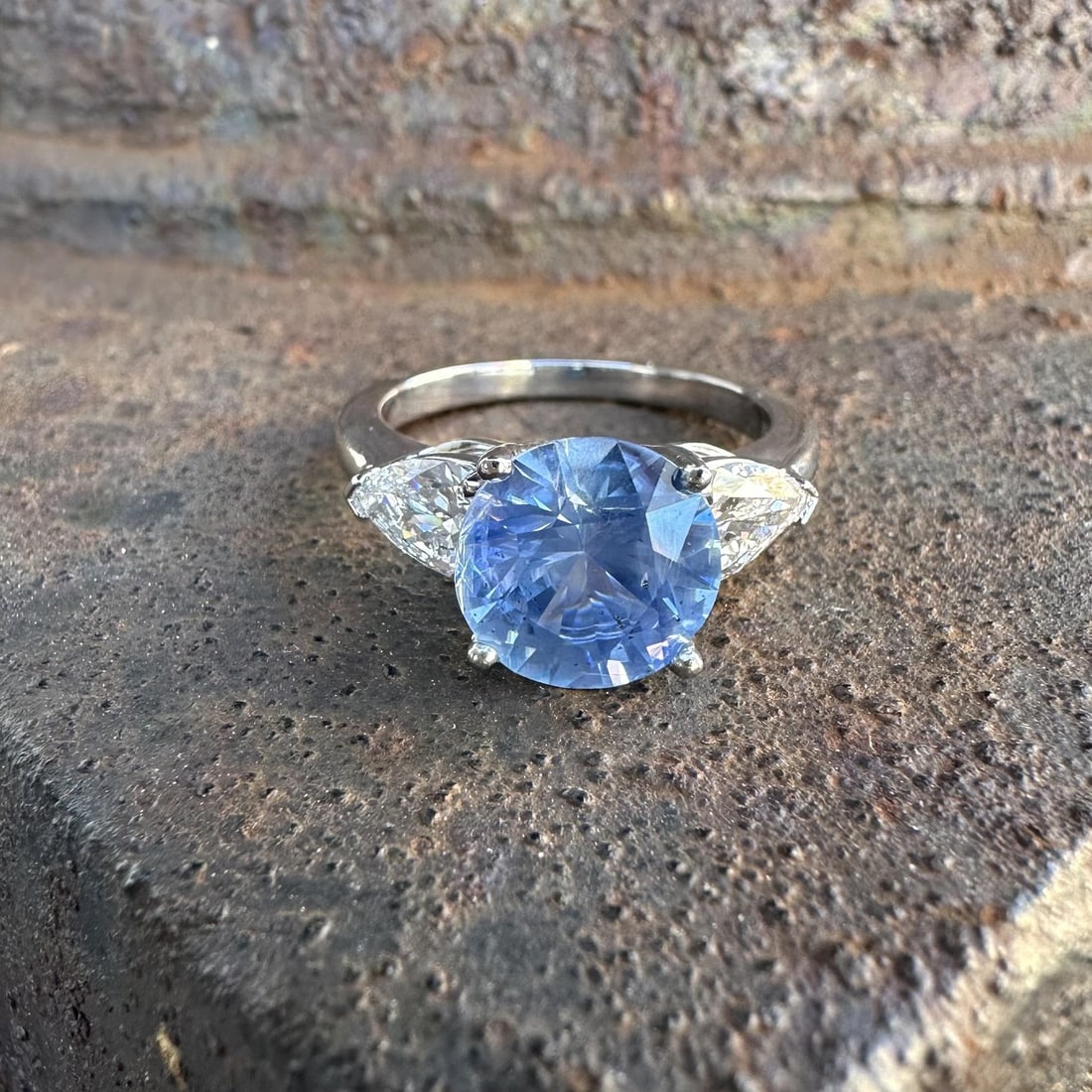 Platinum Ring With GIA Burma No Heat Blue Sapphire and Pear Diamonds 4.22ctw: Platinum Ring With GIA Burma No Heat Blue Sapphire and Pear Diamonds 4.22ctw This platinum cocktail ring features a 3.16 carat natural round-cut Burma sapphire with no indications of heat treatment, d