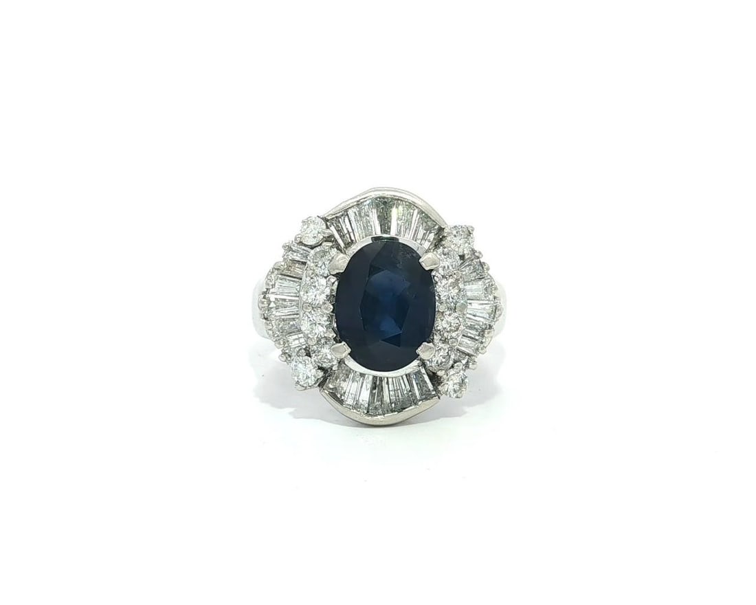 Platinum 3.48ctw Oval Blue Sapphire Ring with Diamond Accents: Platinum 3.48ctw Oval Blue Sapphire Ring with Diamond Accents This stunning cocktail ring features a large, oval brilliant cut sapphire, set in solid 0.880+ platinum, weighing approximately 2.10ct. Th