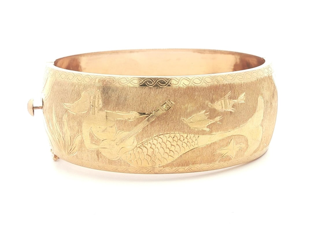 Wide 18k Yellow Gold Mermaid Motif Hand Engraved Hinged Bangle Bracelet: Wide 18k Yellow Gold Mermaid Motif Hand Engraved Hinged Bangle Bracelet This vintage wide hinged bangle is crafted from solid 17-18k yellow gold, stamped 18k. It features a hand-engraved mermaid desig