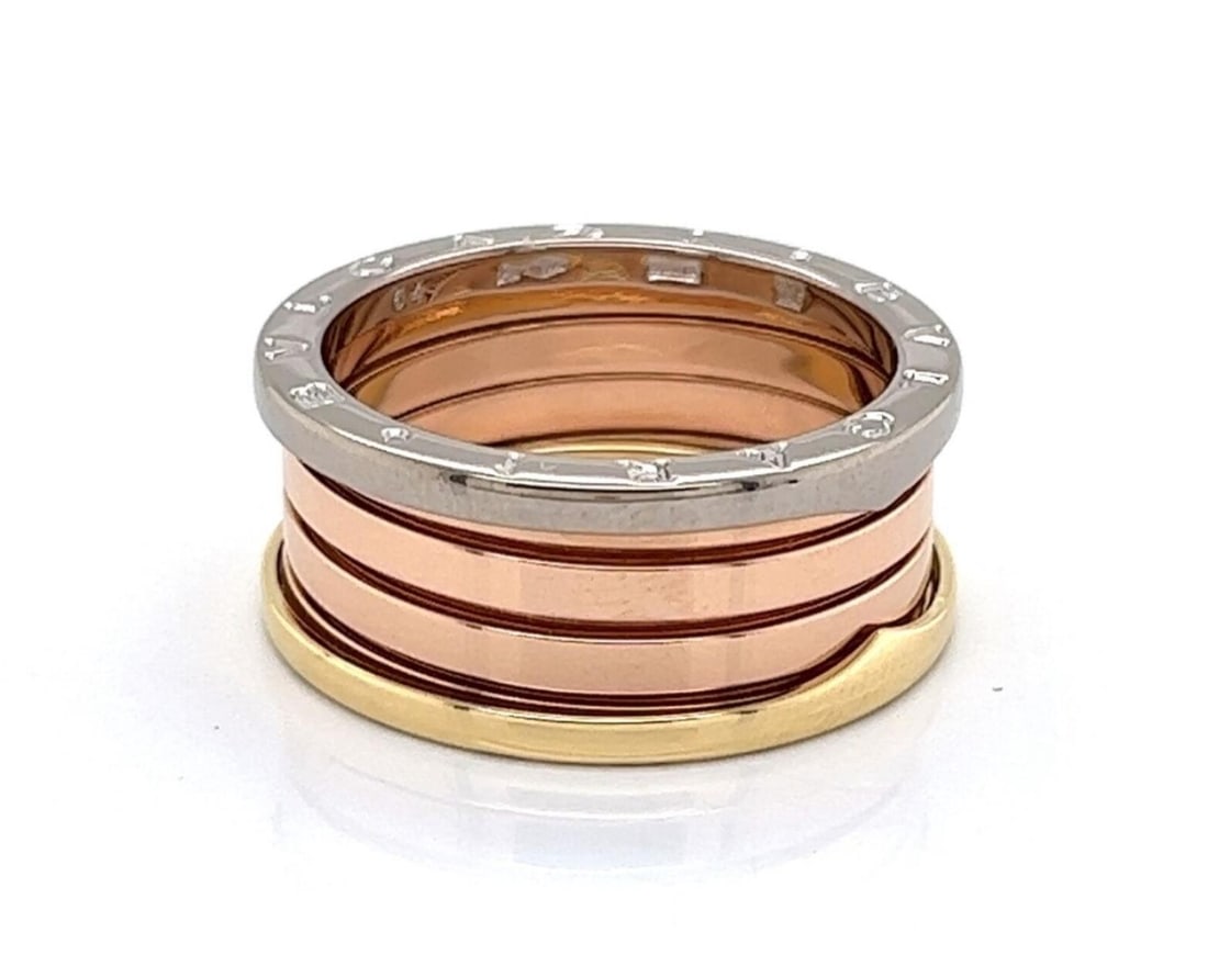 B.zero1 Spiral Band 18k Tri-Color Gold Ring Size 10.5 by Bvlgari: B.zero1 Spiral Band 18k Tri-Color Gold Ring Size 10.5 by Bvlgari This authentic Bvlgari B.zero1 band ring features a striking tri-color design crafted from solid 18k rose, white, and yellow gold. Insp