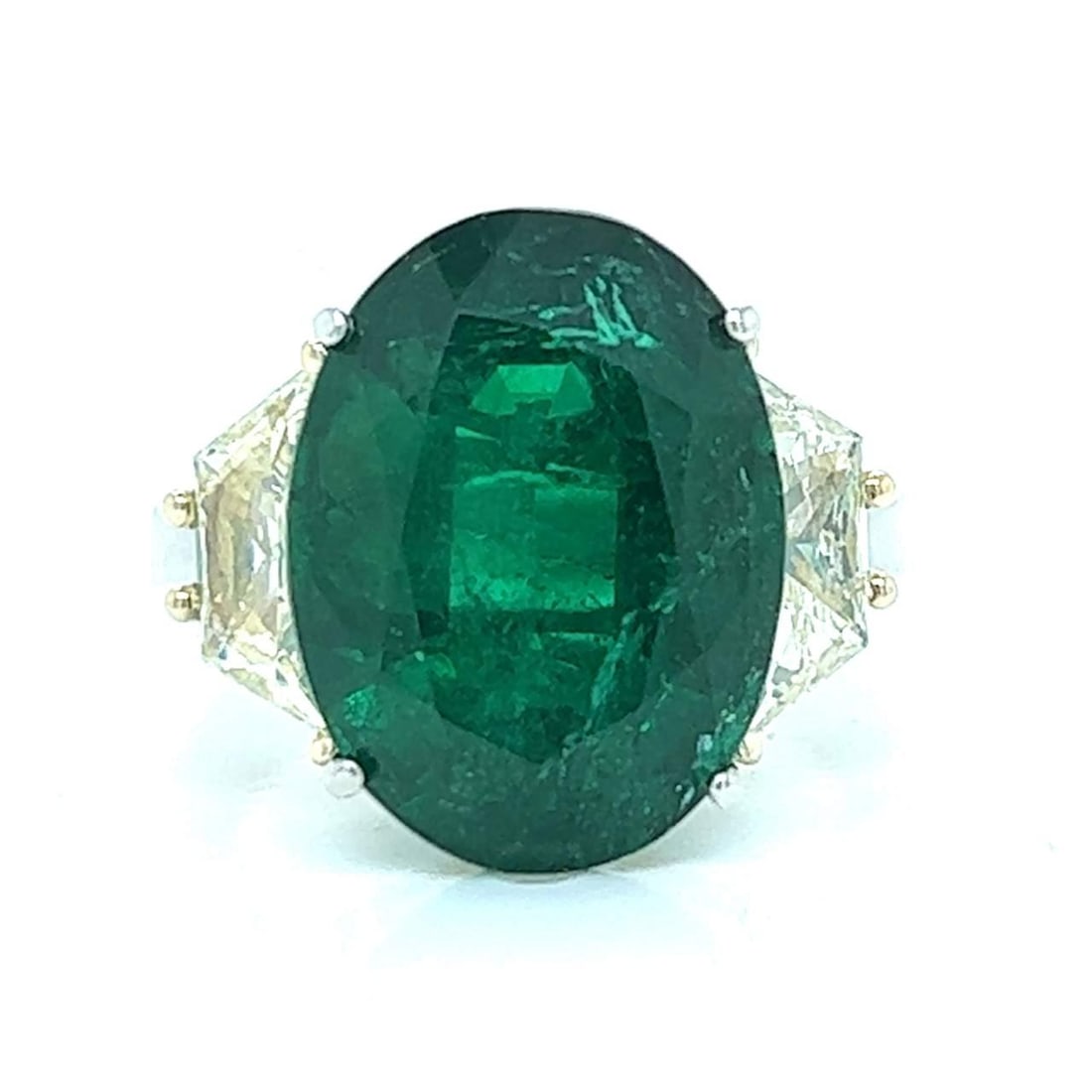Platinum Ring with 10.41 Ct Emerald and 2.50 Ct Fancy Diamonds: Platinum Ring with 10.41 Ct Emerald and 2.50 Ct Fancy Diamonds This exquisite ring features a stunning 10.41 Ct. emerald at its center, elegantly surrounded by two fancy light yellow diamonds weighing