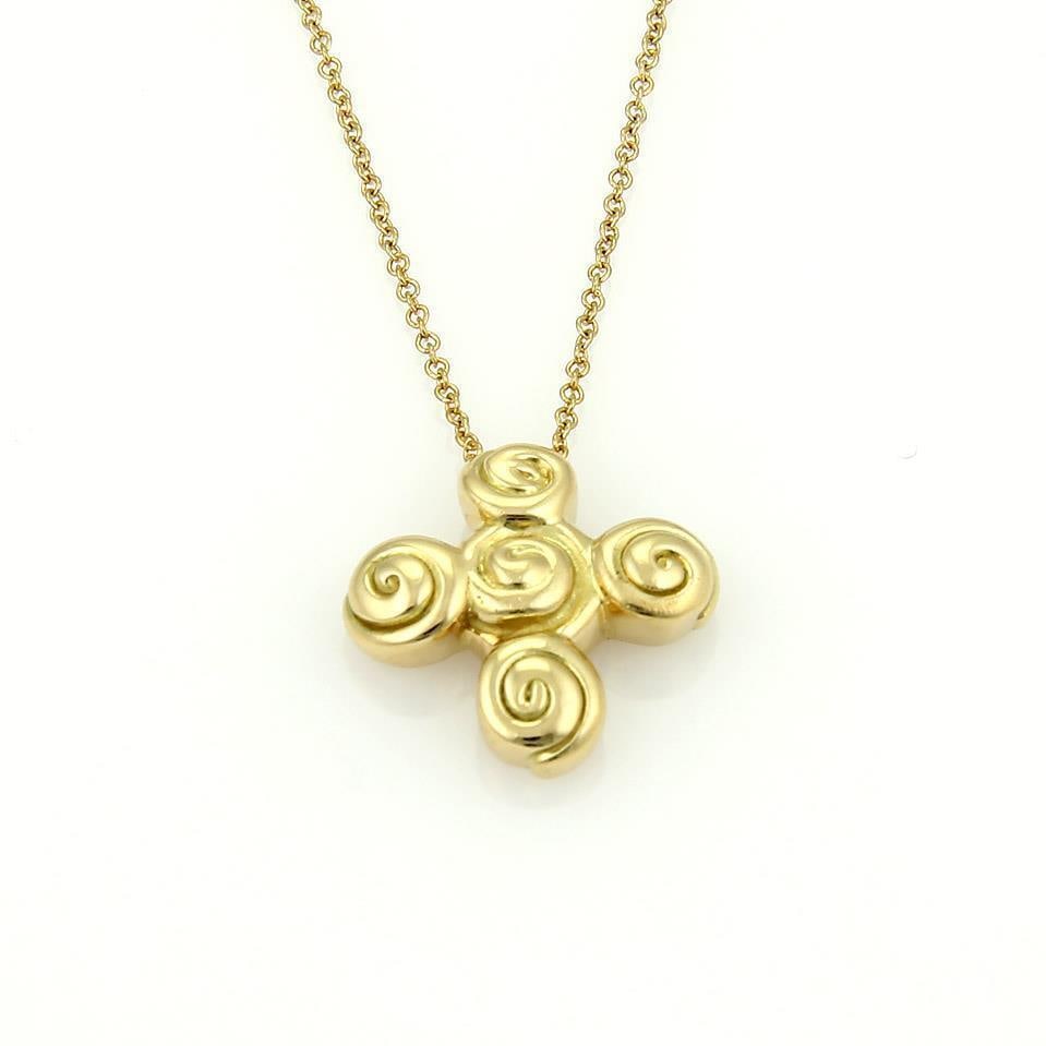 Tiffany & Co. Spiro 18k Yellow Gold Cross Pendant with Chain: Tiffany & Co. Spiro 18k Yellow Gold Cross Pendant with Chain This exquisite Tiffany & Co. pendant and chain are crafted from authentic 18k yellow gold, showcasing the brand's elegant Spiro Collection.