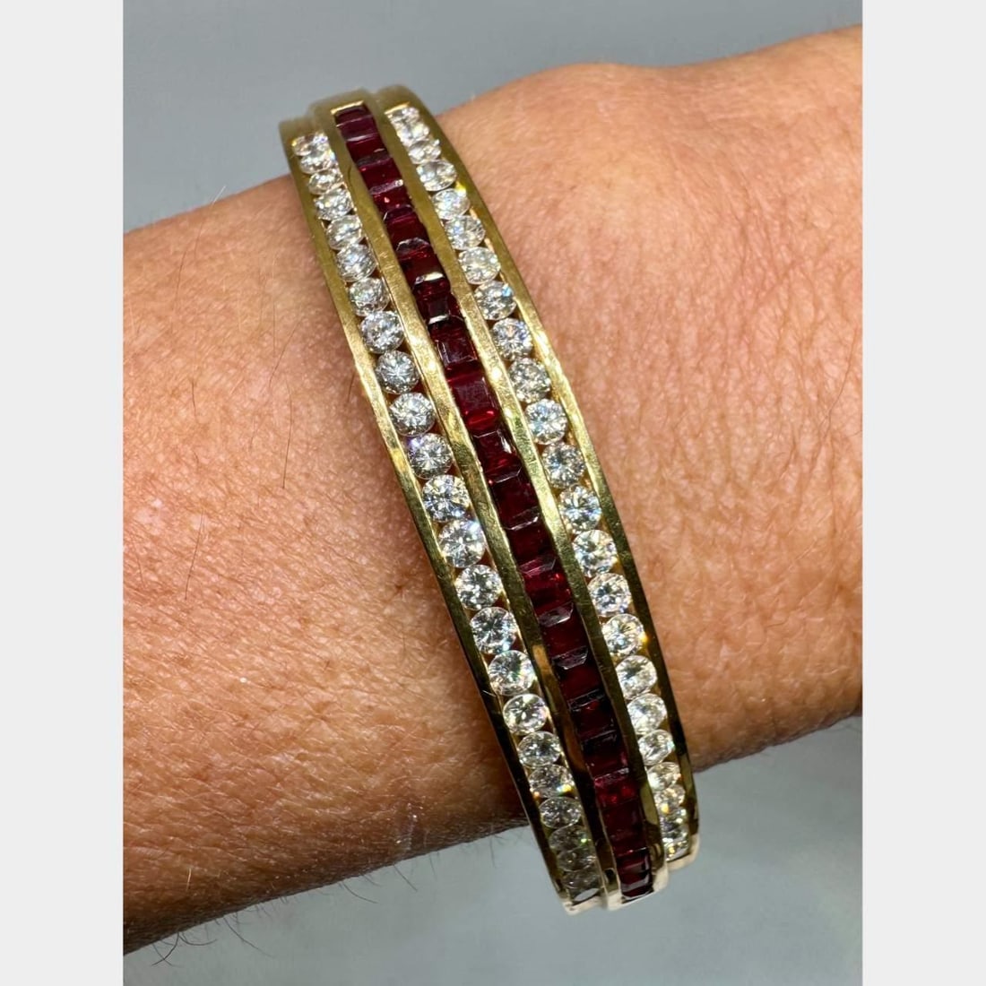 Elegant 18K Yellow Gold Ruby Diamond Bangle 48 Diamonds 24 Rubies: Elegant 18K Yellow Gold Ruby Diamond Bangle 48 Diamonds 24 Rubies This stunning 18K Yellow Gold Bangle features a beautiful arrangement of 48 diamonds and 24 rubies. The diamonds weigh approximately 3
