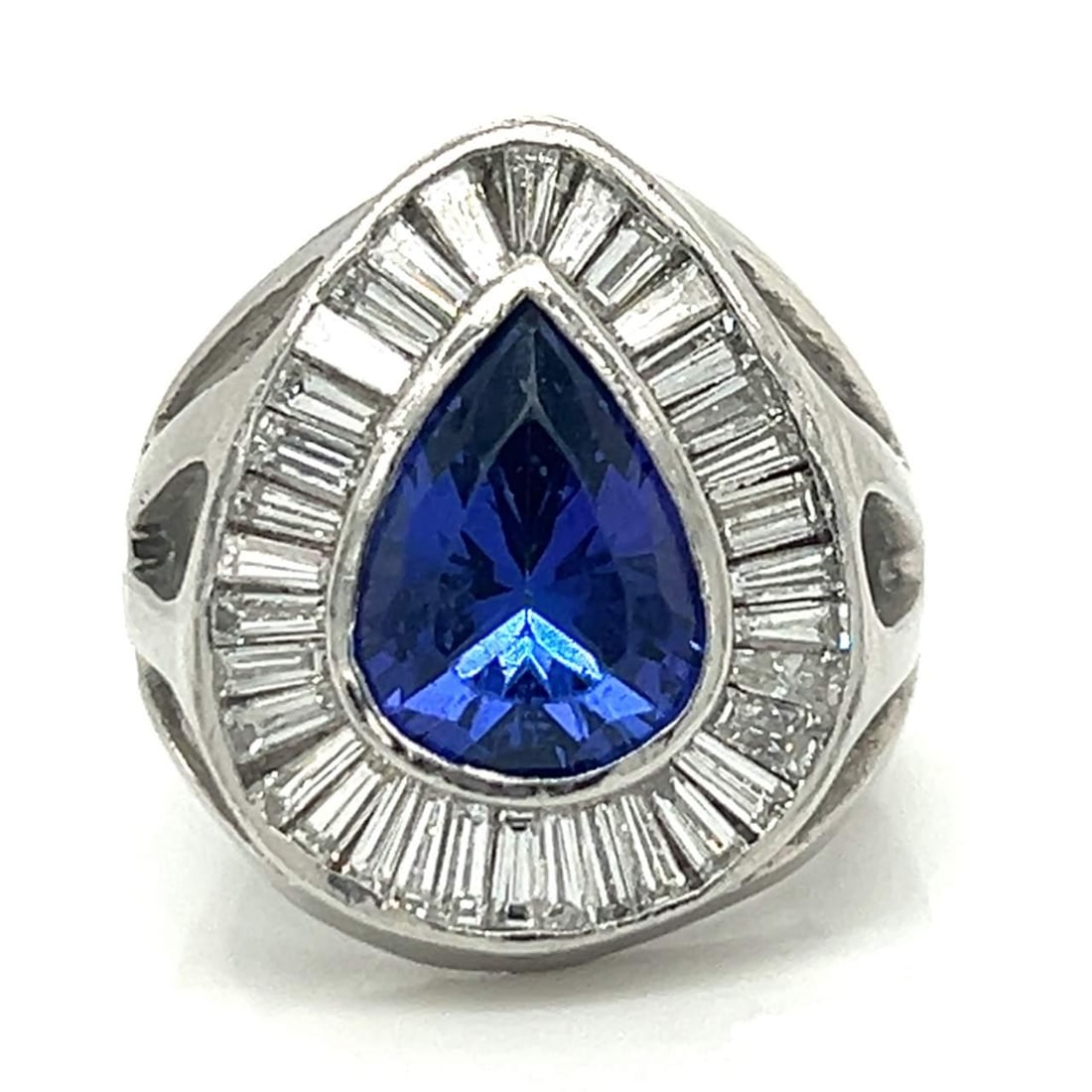 Exquisite Platinum Ring 5.00 Ct Tanzanite 34 Diamonds F-G VVS-VS: Exquisite Platinum Ring 5.00 Ct Tanzanite 34 Diamonds F-G VVS-VS This exquisite platinum ring showcases a stunning approximately 5.00 ct pear-shaped tanzanite at its center, complemented by 34 sparkli