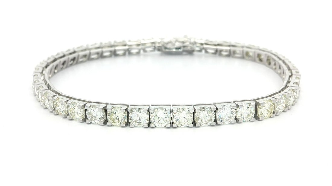 18k White Gold 11.50ctw Round Diamond Line Tennis Bracelet: 18k White Gold 11.50ctw Round Diamond Line Tennis Bracelet This stunning classic tennis bracelet features a beautiful arrangement of 43 natural round brilliant-cut diamonds, totaling approximately 11.