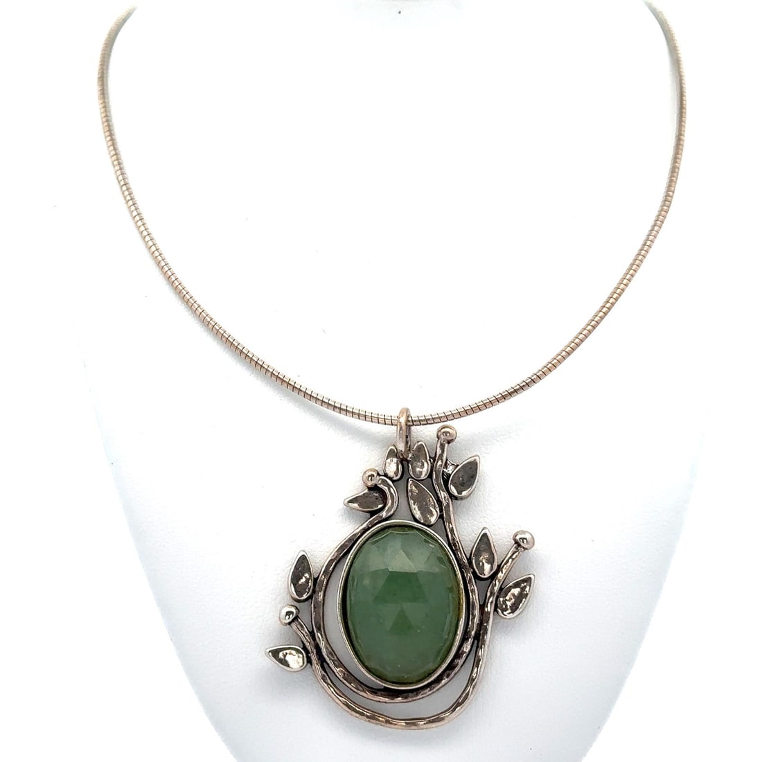 Handmade Sterling Silver Green Jade Pendant Necklace with Climbing Vines Motif: Handmade Sterling Silver Green Jade Pendant Necklace with Climbing Vines Motif This exquisite pendant necklace features a captivating handmade design showcasing a natural green jade stone in a faceted