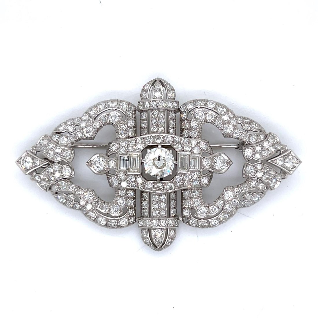 Art Deco Platinum Brooch 12.65 Ct Diamonds J Color VVS Clarity: Art Deco Platinum Brooch 12.65 Ct Diamonds J Color VVS Clarity This stunning Art Deco brooch is crafted in platinum and features a striking central diamond weighing approximately 1.40 Ct. with a J col