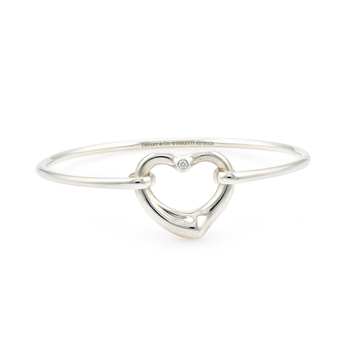 Elsa Peretti Open Heart Diamond Bangle in Sterling Silver by Tiffany & Co.: Elsa Peretti Open Heart Diamond Bangle in Sterling Silver by Tiffany & Co. This Tiffany & Co. Peretti Open Heart Diamond & Sterling Silver Bangle Bracelet features a delicate open heart design set wit