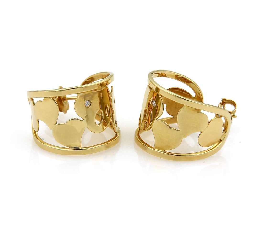 18k Yellow Gold Diamond Hoop Earrings by Roberto Coin with Heart Motif: 18k Yellow Gold Diamond Hoop Earrings by Roberto Coin with Heart Motif These Roberto Coin hoop earrings are crafted from 18k yellow gold and feature an open wide heart-shaped design, each highlighted