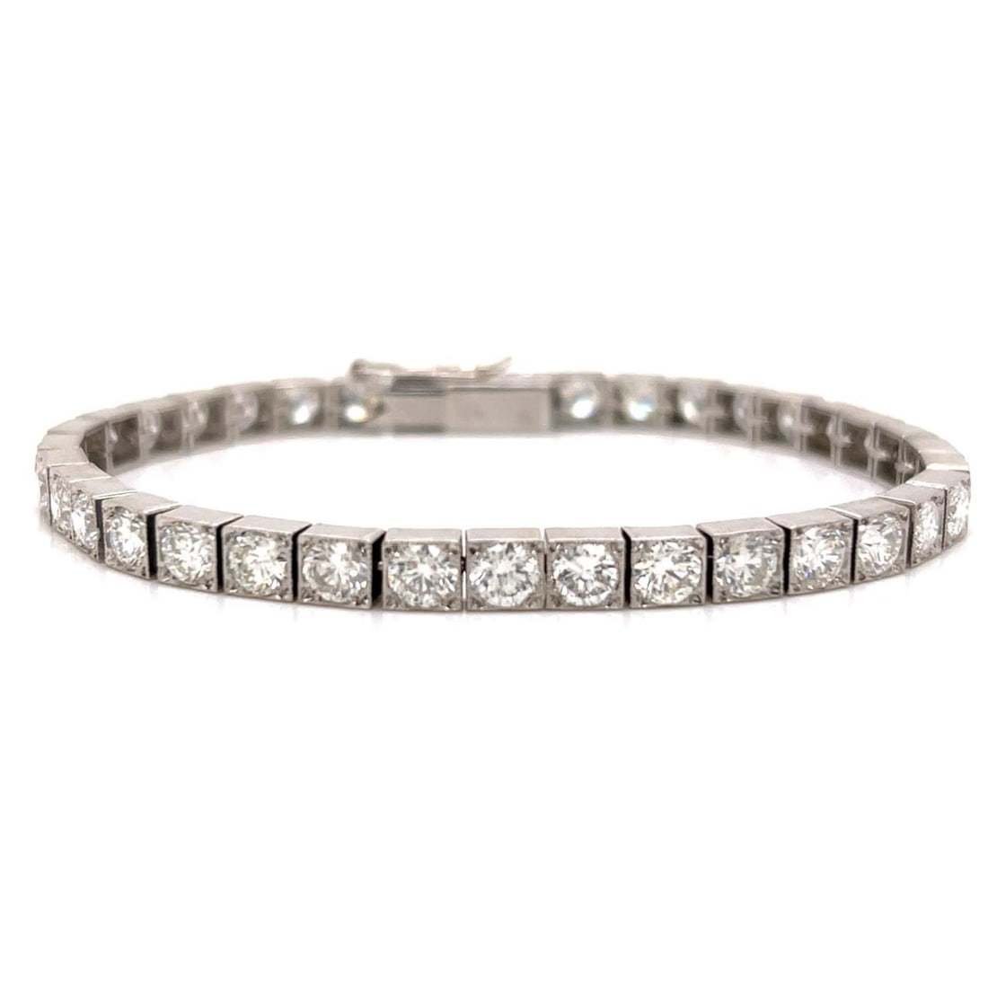 Diamond Tennis Bracelet in Platinum with 12.00 Carat Total Weight: Diamond Tennis Bracelet in Platinum with 12.00 Carat Total Weight This platinum tennis bracelet features 37 diamonds with a total weight of approximately 12.00 carats. The diamonds are graded H-I colo