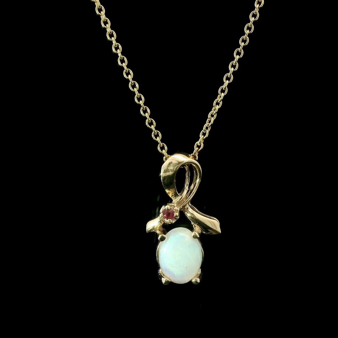 Estate 14k Yellow Gold Opal Ruby Ribbon Pendant Adjustable Chain: Estate 14k Yellow Gold Opal Ruby Ribbon Pendant Adjustable Chain This exquisite estate pendant showcases a stunning combination of natural opal and ruby, elegantly crafted in solid 14k yellow gold. Th