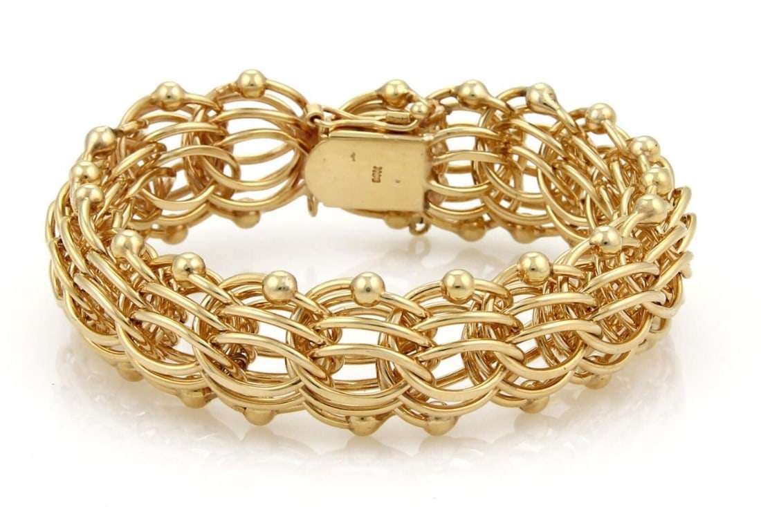 Vintage 14k Yellow Gold Multi-Ring Charm Bracelet 20mm Wide: Vintage 14k Yellow Gold Multi-Ring Charm Bracelet 20mm Wide This vintage charm bracelet is crafted from 14k yellow gold and showcases a striking multi-ring design with a 20mm width. The bracelet is ha
