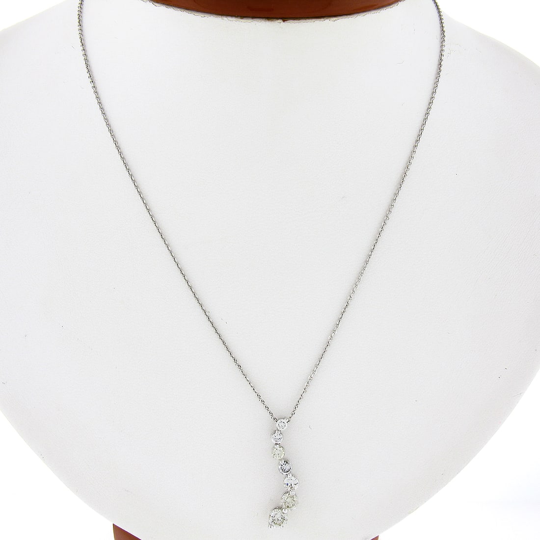 14K White Gold 1.10ctw Diamond Journey Pendant with 18 Inch Cable Chain: 14K White Gold 1.10ctw Diamond Journey Pendant with 18 Inch Cable Chain This exquisite pendant showcases a wavy journey design, crafted in solid 14k white gold. It features 7 natural round brilliant c