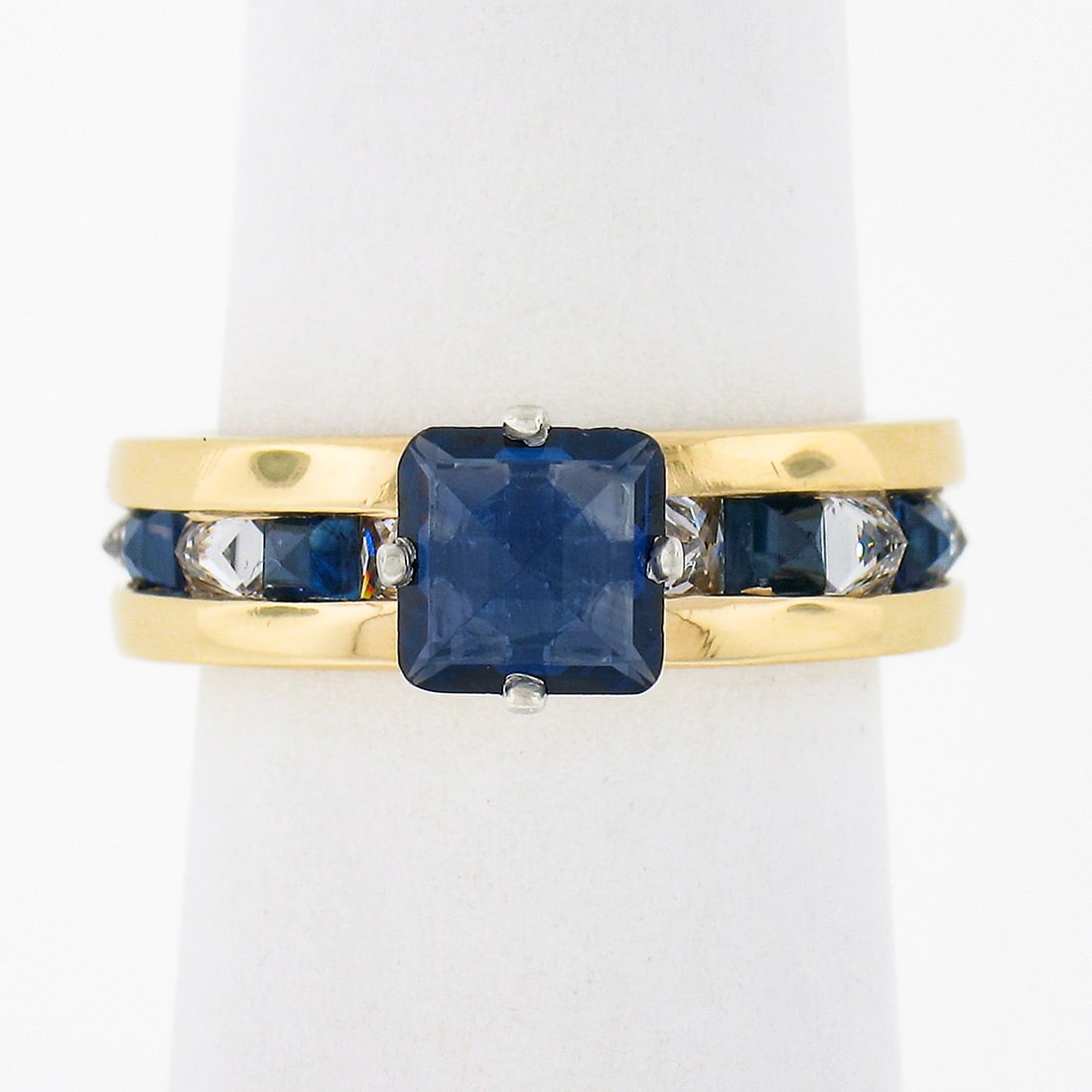 14K Gold 2.35ct Reverse Set Sapphire Diamond Engagement Ring: 14K Gold 2.35ct Reverse Set Sapphire Diamond Engagement Ring This exquisite 14K Gold engagement ring features a stunning 2.35ctw reverse set square sapphire solitaire surrounded by alternating sapphir