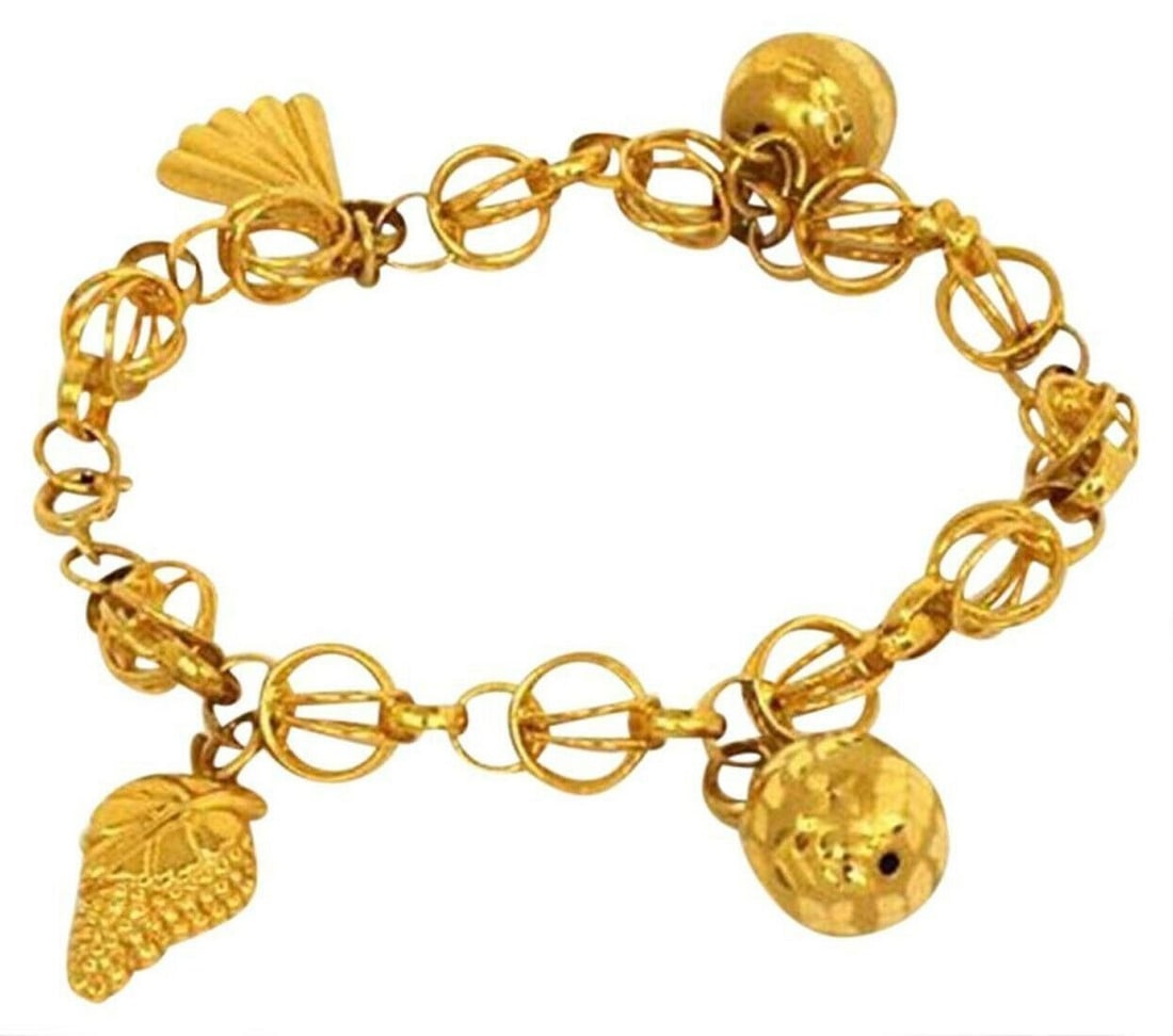 Vintage 21k Gold Bracelet With Four Distinctive Dangling Charms: Vintage 21k Gold Bracelet With Four Distinctive Dangling Charms This vintage 21k yellow gold link bracelet showcases four unique dangling charms, including a fan, a fruit, and two gold ball motifs. Ea