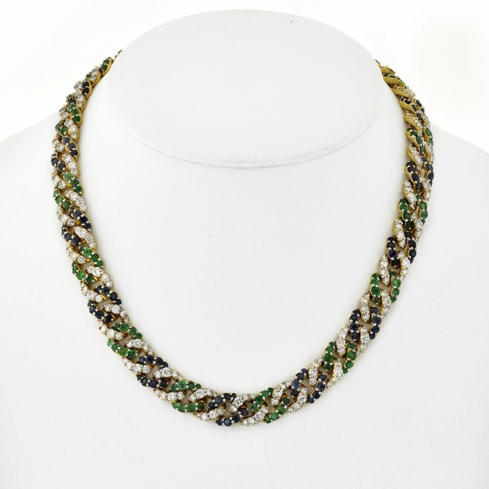 18K Yellow Gold Cuban Link Necklace with Diamonds Sapphires Emeralds: 18K Yellow Gold Cuban Link Necklace with Diamonds Sapphires Emeralds This stunning 18K Yellow Gold Cuban Link Necklace is a luxurious accessory that showcases an exquisite combination of diamonds, sap