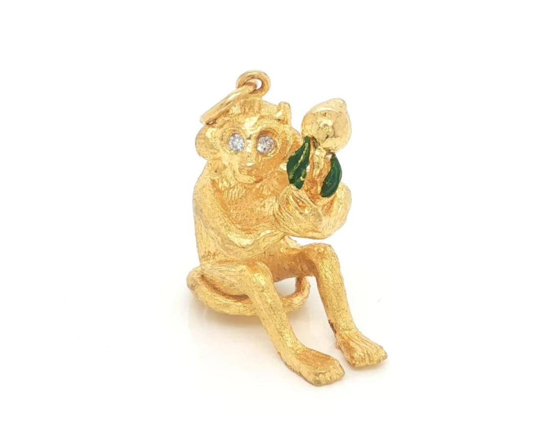 24k Yellow Gold Enamel Monkey Charm Pendant with Diamond Accent: 24k Yellow Gold Enamel Monkey Charm Pendant with Diamond Accent This rare full-figure monkey charm pendant is expertly crafted from solid 24k yellow gold, featuring vibrant green enamel accents and a