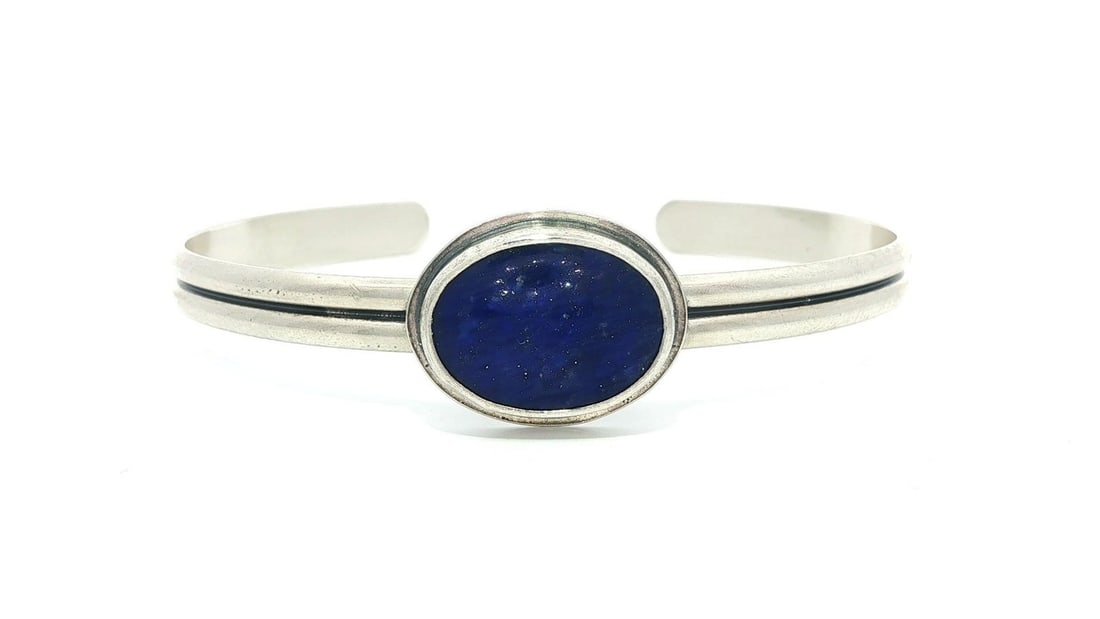 Navajo Vintage Sterling Silver Lapis Lazuli Grooved Cuff Bangle Bracelet: Navajo Vintage Sterling Silver Lapis Lazuli Grooved Cuff Bangle Bracelet This exquisite vintage bangle bracelet showcases a stunning natural lapis lazuli stone set in a beautifully crafted sterling si