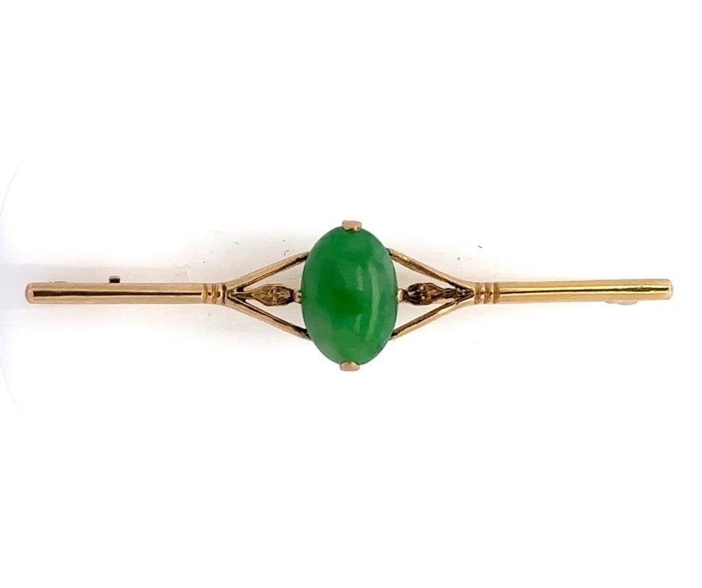 Victorian 18K Yellow Gold Jade Cabochon Bar Brooch Prong Set: Victorian 18K Yellow Gold Jade Cabochon Bar Brooch Prong Set This exquisite Antique Victorian bar pin is crafted in 18K yellow gold and features a striking natural jade cabochon stone. The vibrant gre